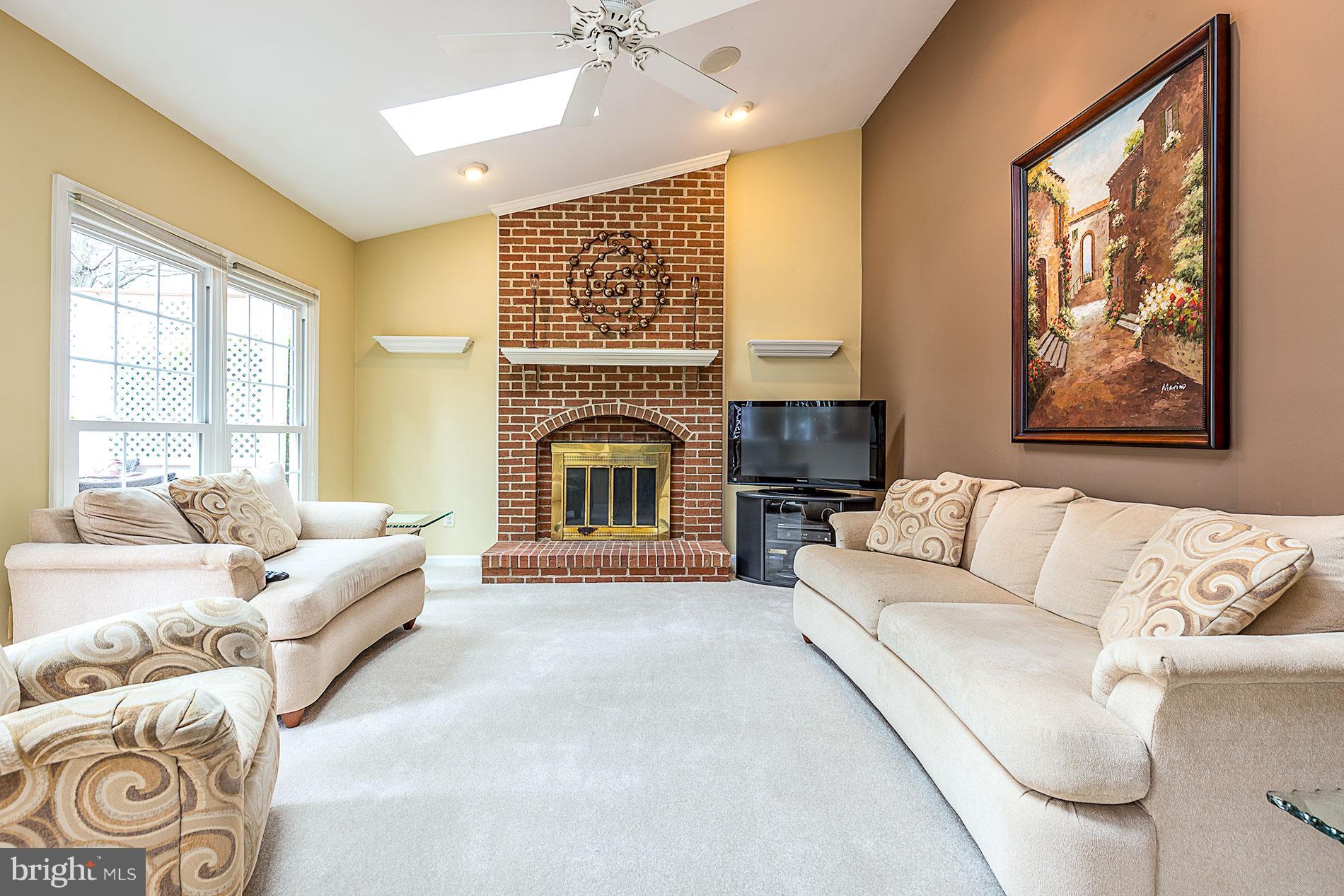 6453 Springhouse Circle Clifton, VA 20124 - Photo 14 of 30 a living room with furniture and a fireplace