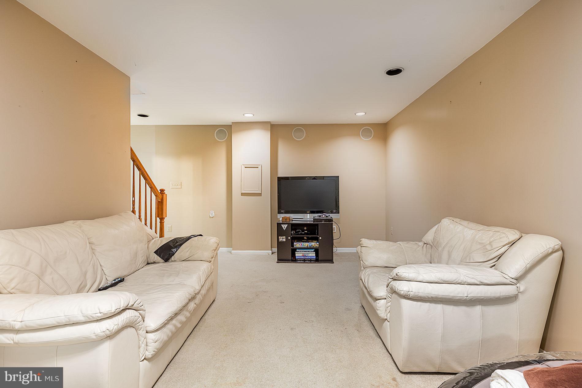 6453 Springhouse Circle Clifton, VA 20124 - Photo 26 of 30 a living room with furniture and a flat screen tv
