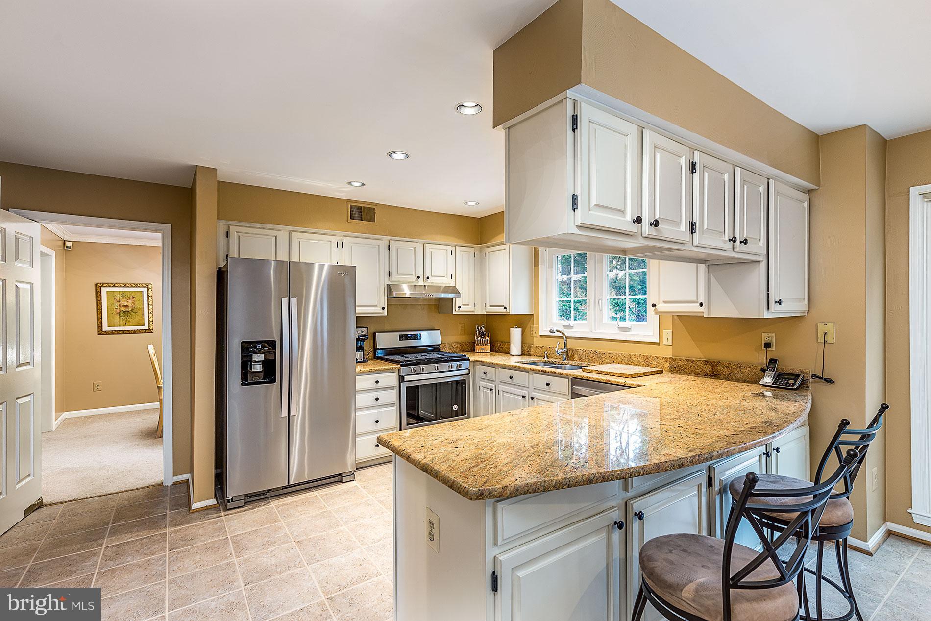 6453 Springhouse Circle Clifton, VA 20124 - Photo 8 of 30 a kitchen with stainless steel appliances granite countertop a sink refrigerator and cabinets