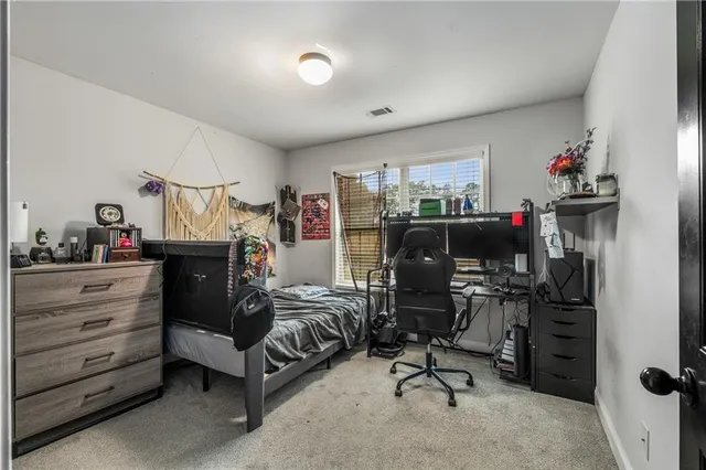 a bedroom with furniture and a flat screen tv