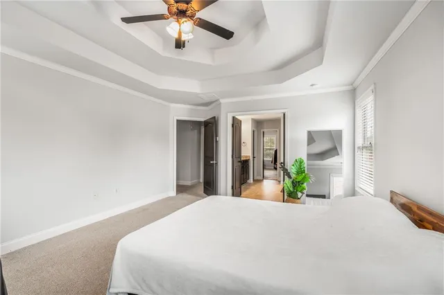 a bedroom with a bed and ceiling fan