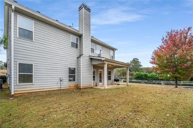 a backyard of a house with table and chairs