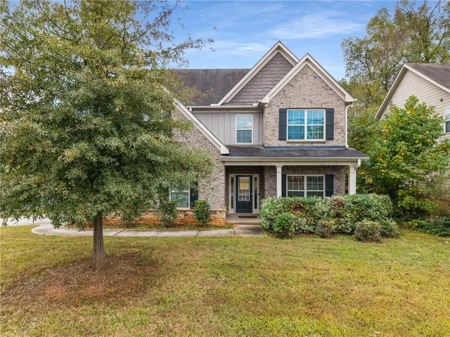 a front view of a house with garden
