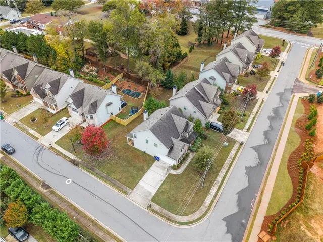 an aerial view of residential house with outdoor space and swimming pool