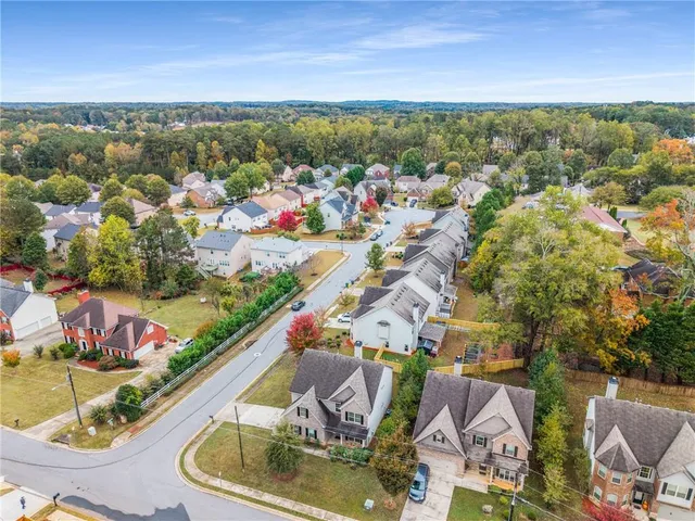 an aerial view of residential houses with outdoor space