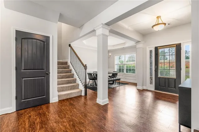 a view of a livingroom with furniture hardwood floor and staircase