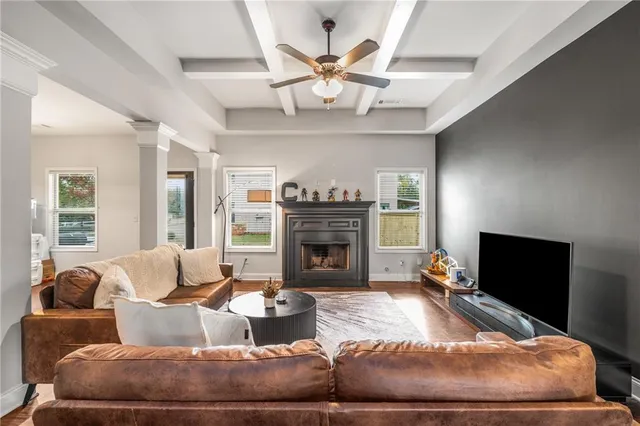 a living room with furniture a fireplace and a large window