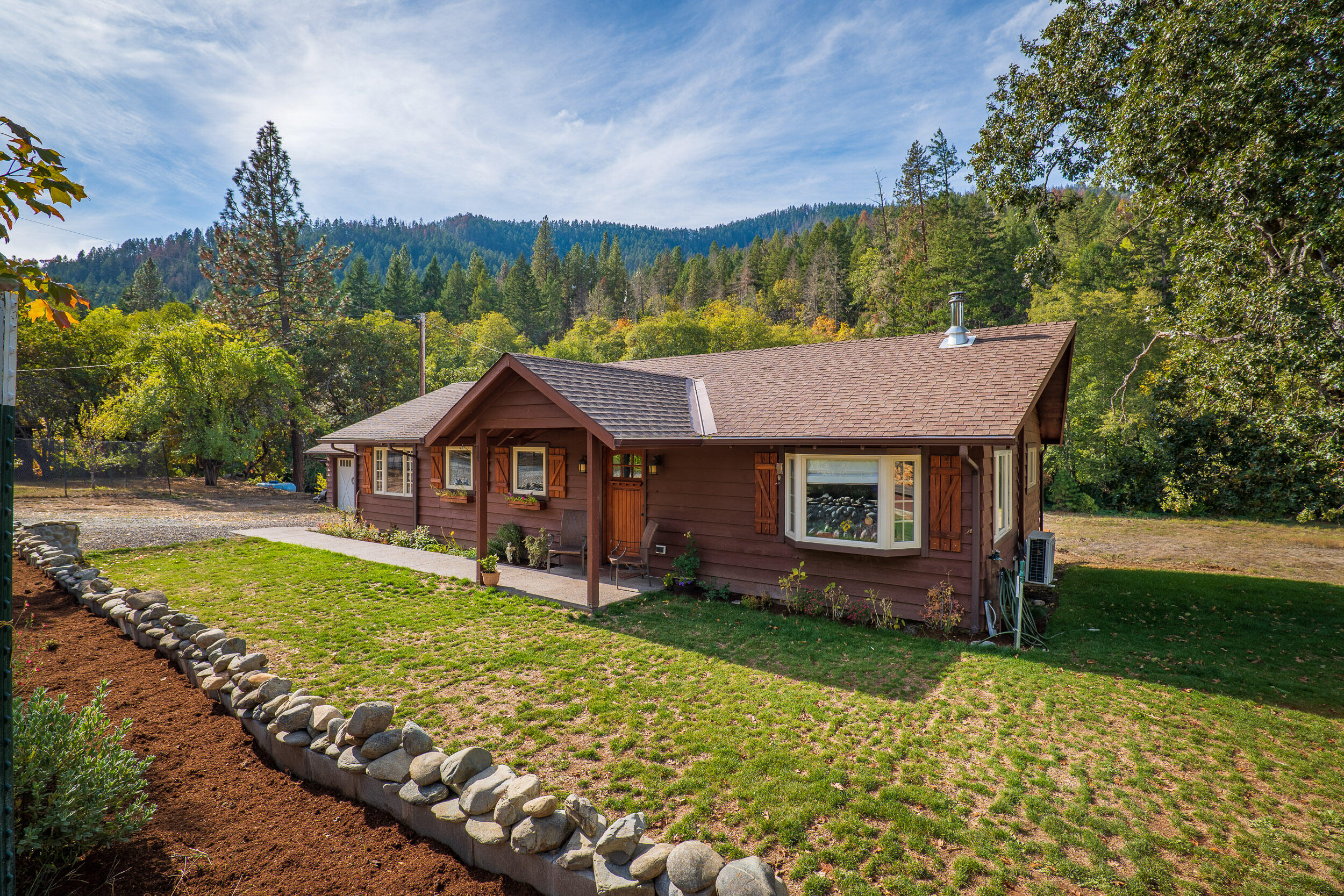 3732-3786 Little Applegate Road Jacksonville, OR 97530 - Photo 10 of 72 a view of a house with a yard and potted plants