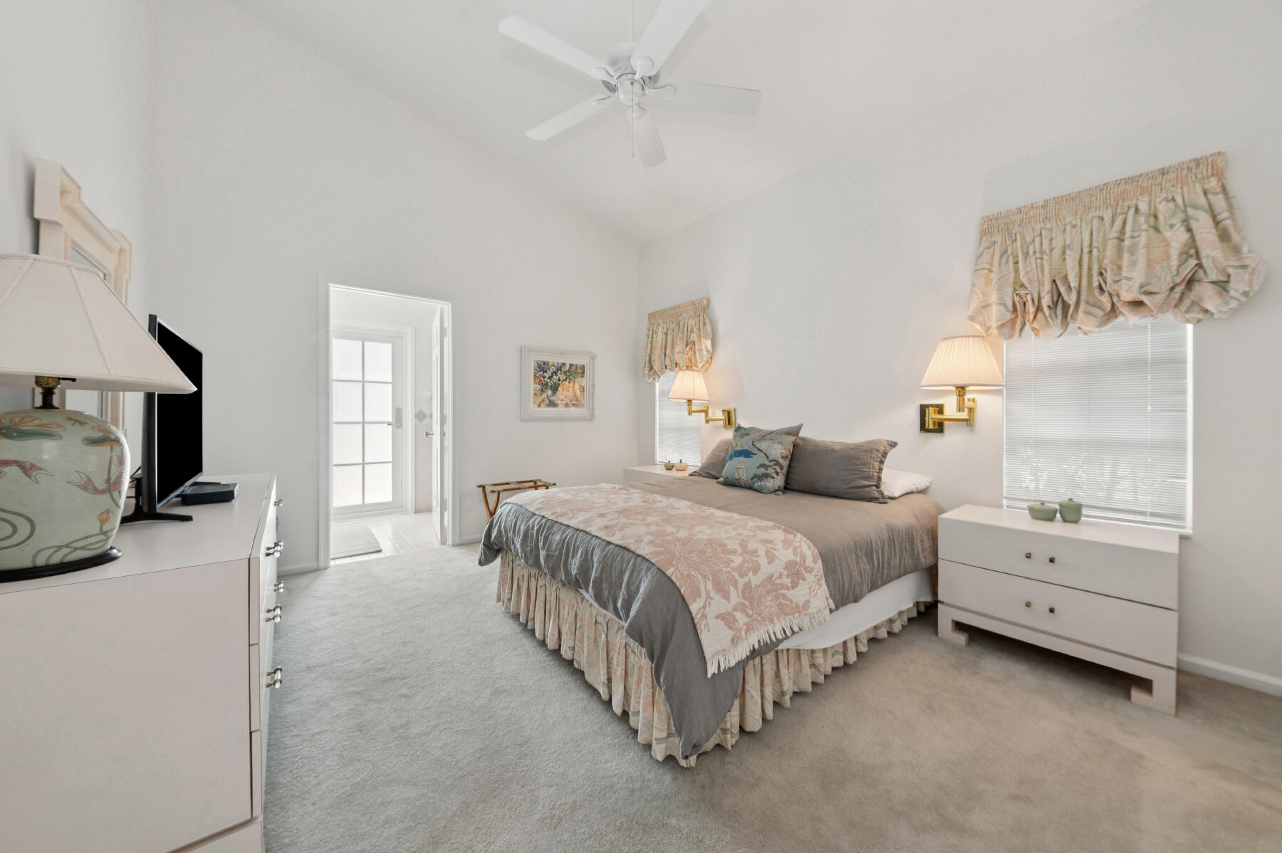 10403 Stonebridge Boulevard Boca Raton, FL 33498 - Photo 18 of 51 a spacious bedroom with a bed and a flat tv screen on dresser