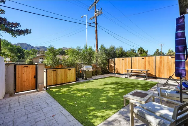 a view of a backyard with sitting area