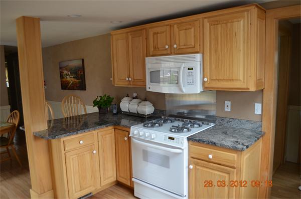 181 Butler Road Monson, MA 01057 - Photo 15 of 24 a kitchen with stainless steel appliances granite countertop a stove a sink a refrigerator white cabinets and wooden floor