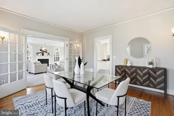 a dining room with furniture and wooden floor