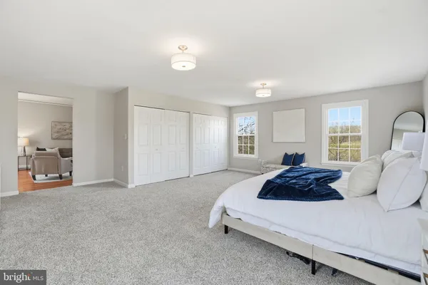 a spacious bedroom with a bed and a window