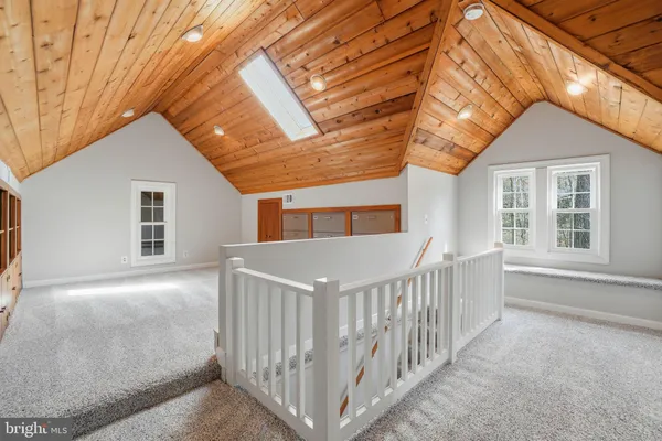 a view of a house with a small yard and wooden fence