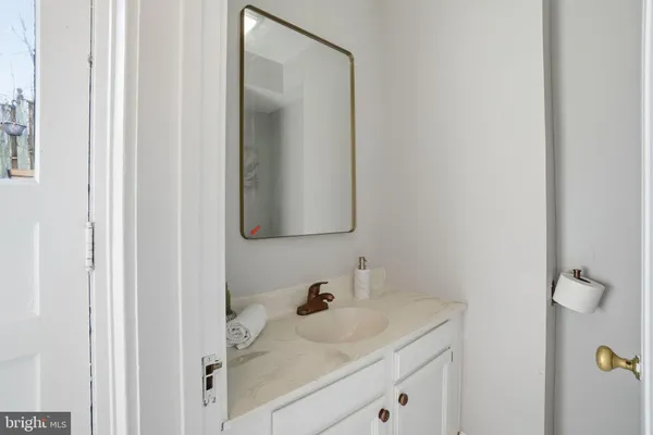 a bathroom with a granite countertop sink and a mirror