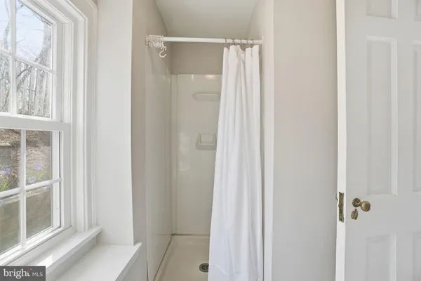 a bathroom with a glass shower door