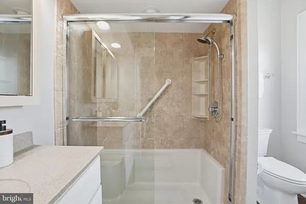 a bathroom with a shower and a sink