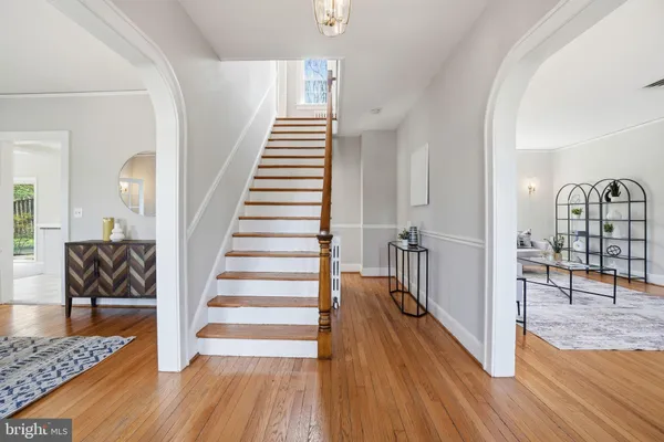 a view of entryway and hall with wooden floor