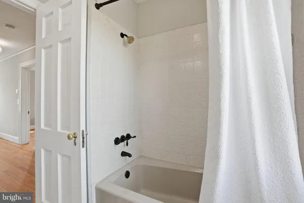a bathroom with bathtub and shower
