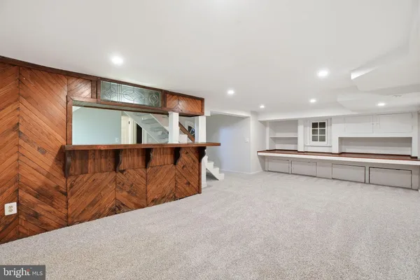 a view of kitchen with stainless steel appliances cabinets
