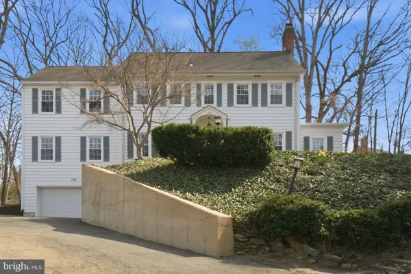 a view of a house with a large tree
