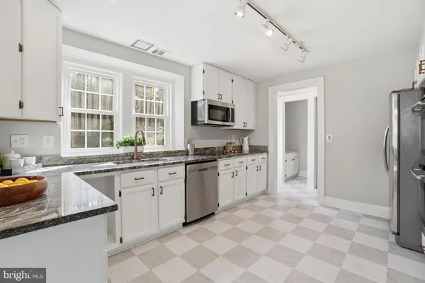 a kitchen with a sink stove and refrigerator