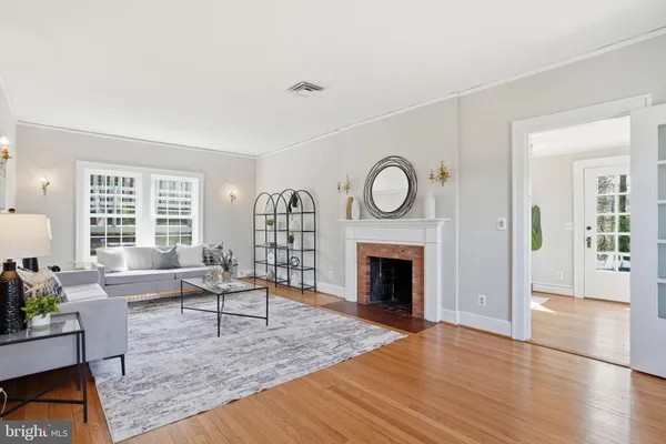 a living room with furniture a fireplace and window