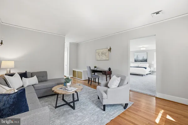 a living room with furniture and wooden floor