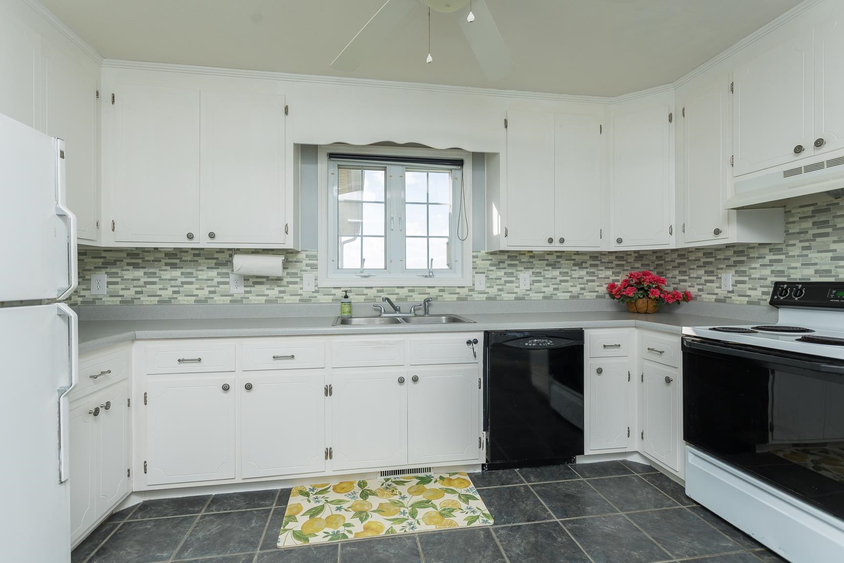 5482 Williams Run Road Mount Crawford, VA 22841 - Photo 18 of 46 a kitchen with granite countertop white cabinets stainless steel appliances a sink and a window