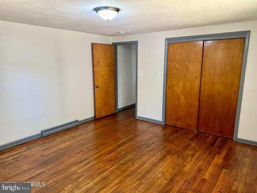 135 South Main Street Barnegat, NJ 08005 - Photo 11 of 35 an empty room with wooden floor and sliding door