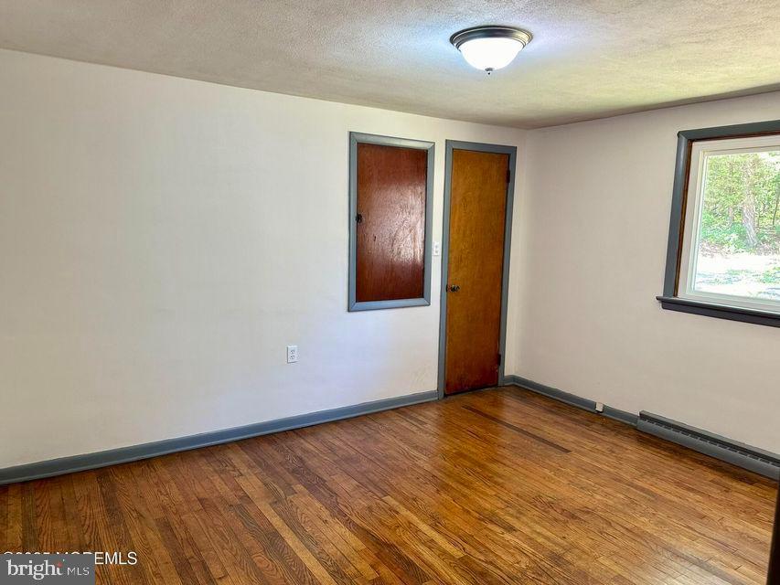 135 South Main Street Barnegat, NJ 08005 - Photo 16 of 35 an empty room with wooden floor and windows