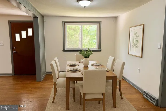 a dining room with furniture and window