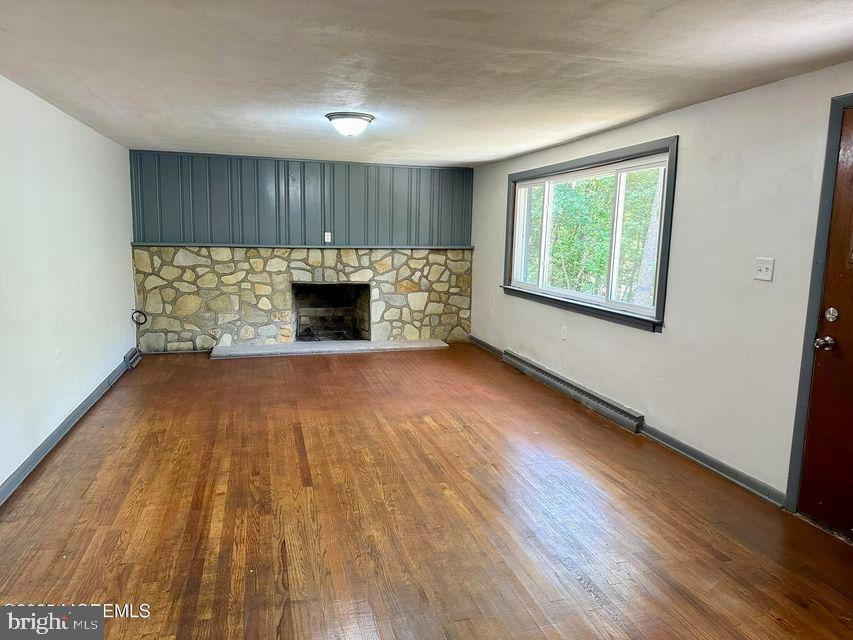 135 South Main Street Barnegat, NJ 08005 - Photo 3 of 35 an empty room with wooden floor a fireplace and windows