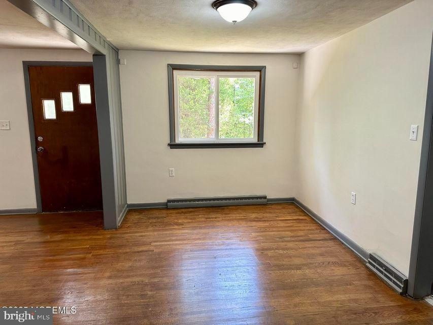 135 South Main Street Barnegat, NJ 08005 - Photo 5 of 35 an empty room with wooden floor and windows