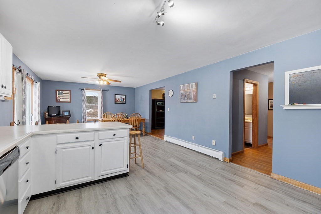 164 Sterling Road Princeton, MA 01541 - Photo 12 of 36 a large white kitchen with wooden floors