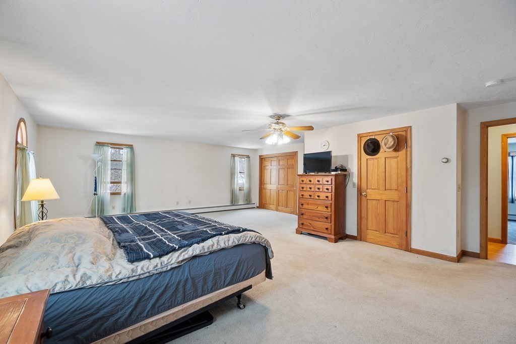 164 Sterling Road Princeton, MA 01541 - Photo 19 of 36 a bedroom with a large bed and a couch