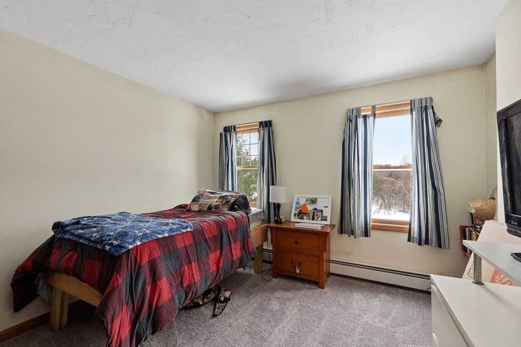 164 Sterling Road Princeton, MA 01541 - Photo 27 of 36 a bed sitting in a bedroom next to a window