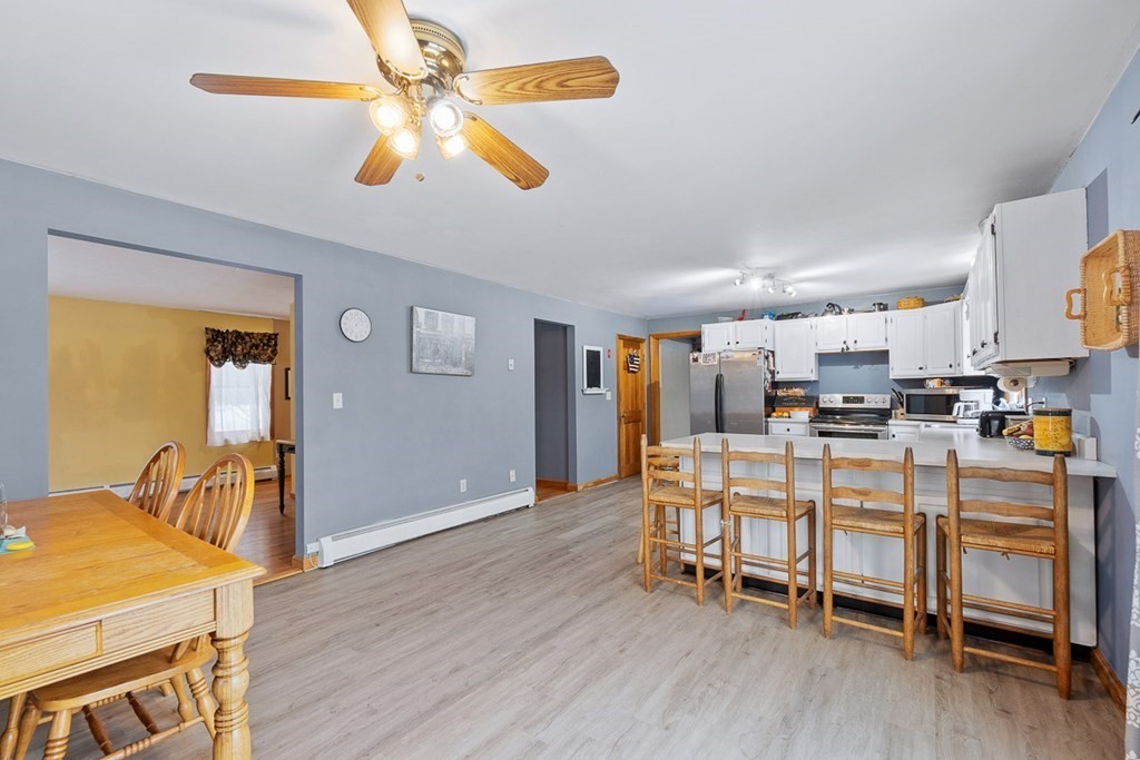 164 Sterling Road Princeton, MA 01541 - Photo 9 of 36 a dining room with wooden floor and a chandelier