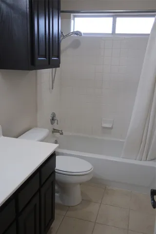 a bathroom with a shower and a glass door