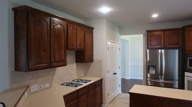 a kitchen with stainless steel appliances a refrigerator and a stove