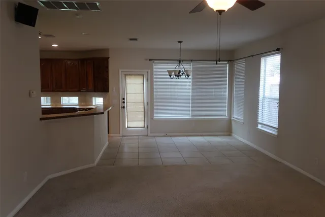 a view of a house with backyard and a tree