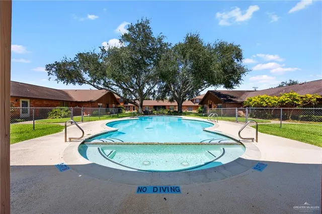 a view of a swimming pool with a patio