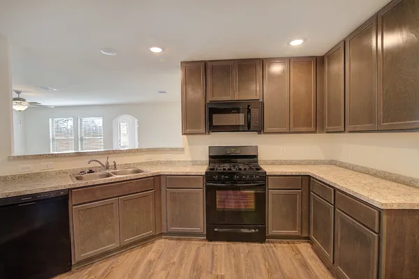 a kitchen with a sink stove and cabinets