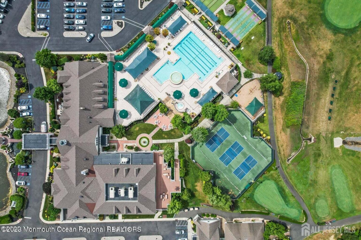 47 Kings Mill Road Monroe Township, NJ 08831 - Photo 28 of 38 an aerial view of a residential apartment building with a yard and parking spaces