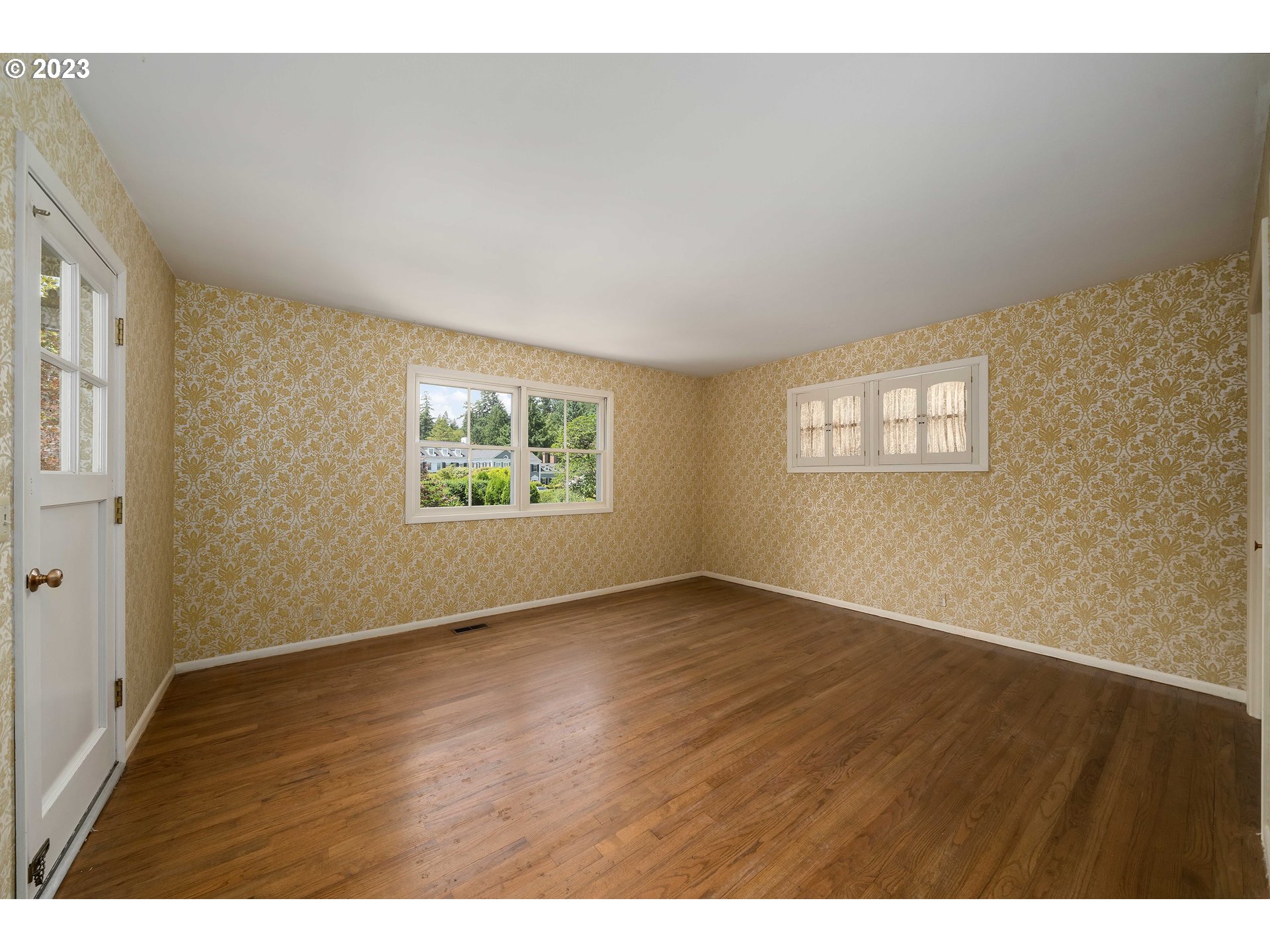 3815 Southwest 50th Avenue Portland, OR 97221 - Photo 12 of 36 an empty room with wooden floor and windows
