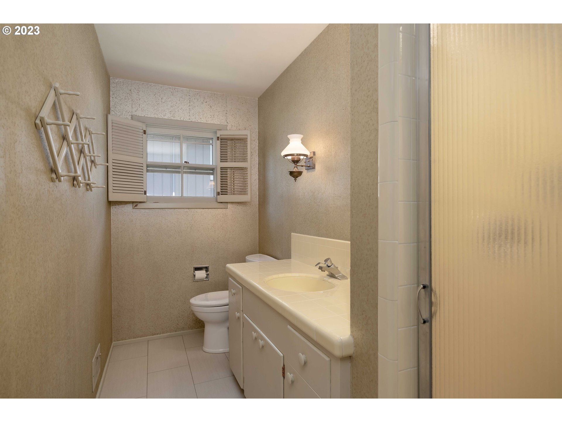 3815 Southwest 50th Avenue Portland, OR 97221 - Photo 13 of 36 a bathroom with a sink a toilet and shower