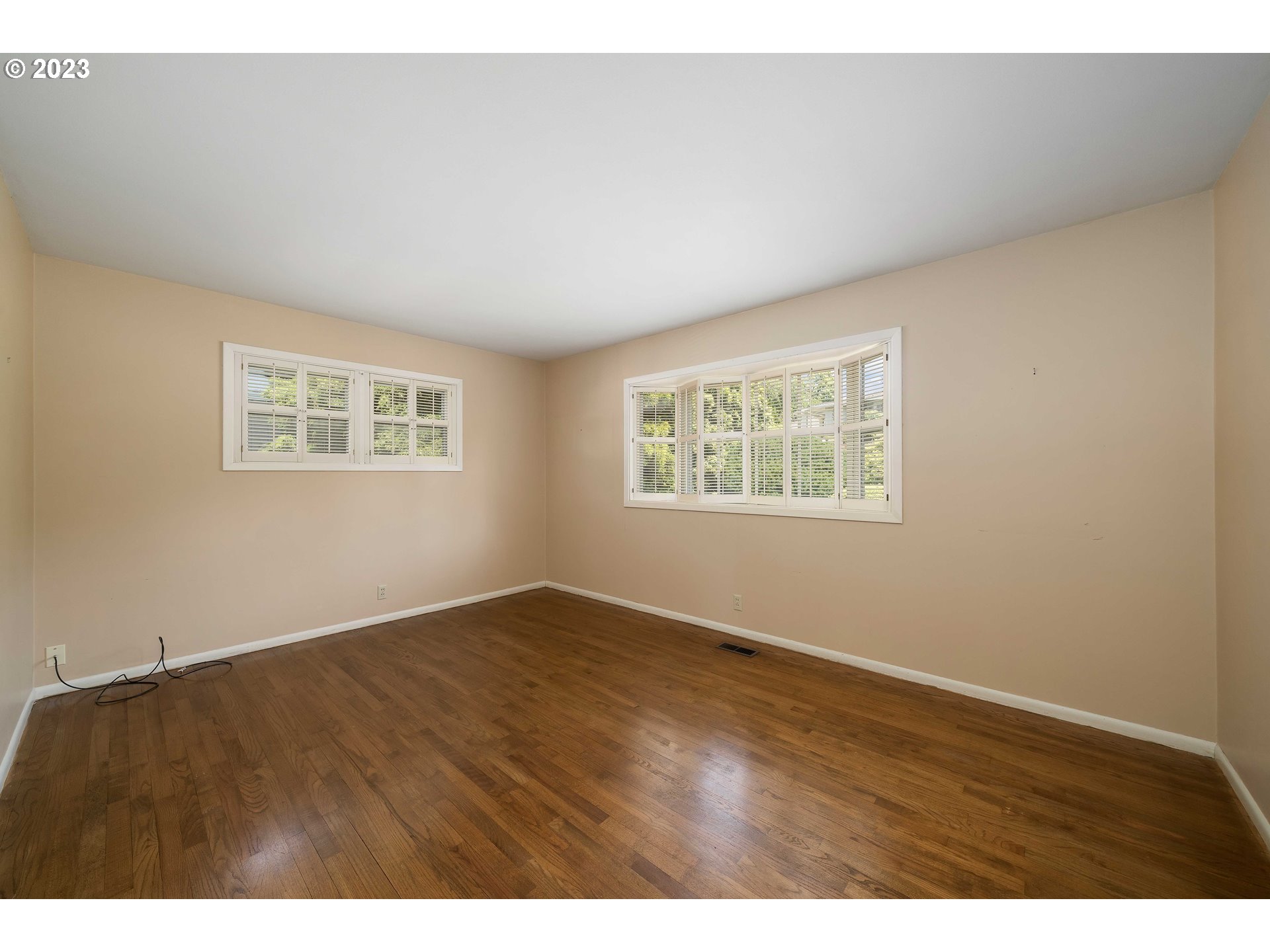 3815 Southwest 50th Avenue Portland, OR 97221 - Photo 14 of 36 an empty room with wooden floor and windows