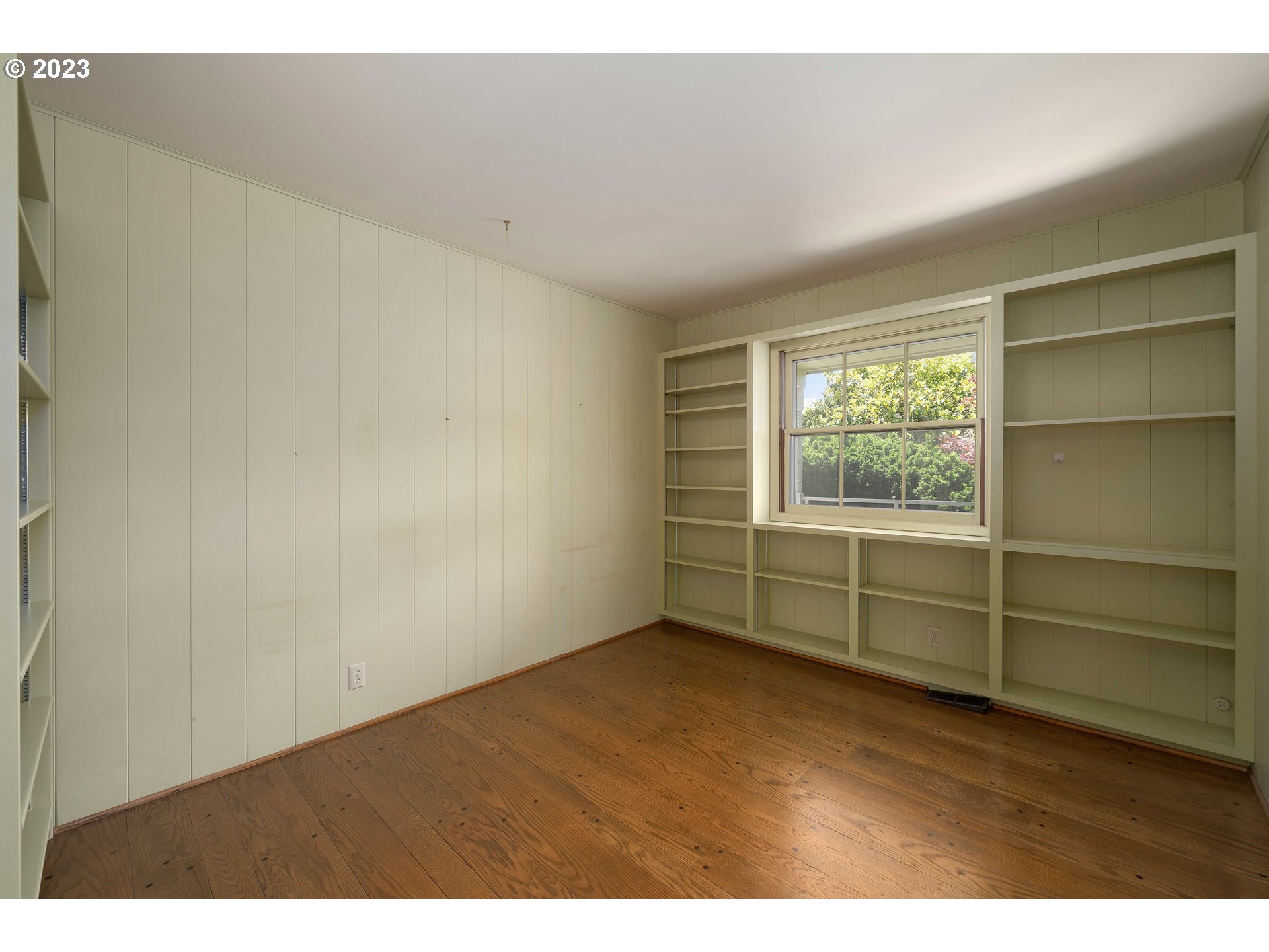 3815 Southwest 50th Avenue Portland, OR 97221 - Photo 15 of 36 an empty room with wooden floor and windows