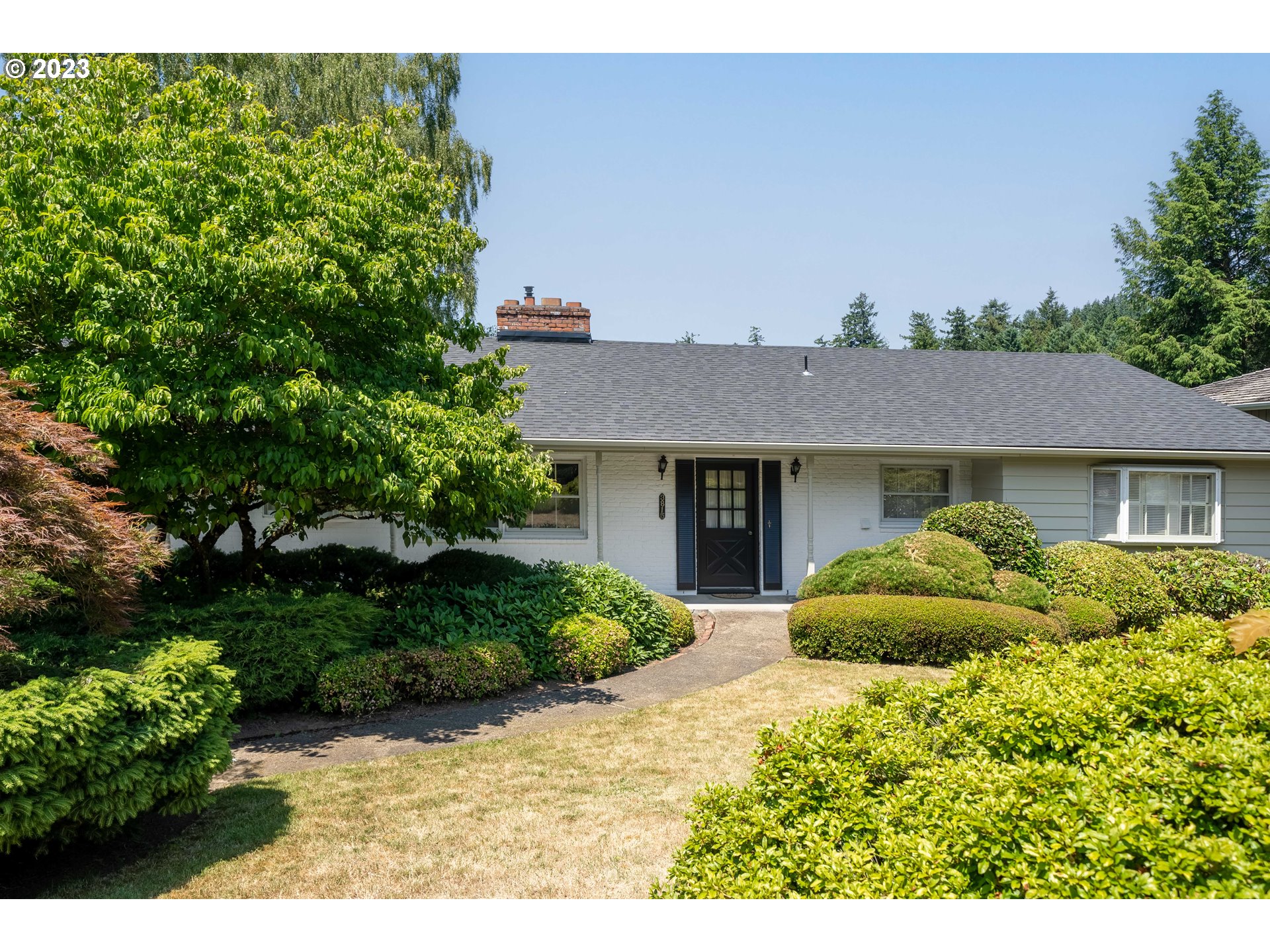 3815 Southwest 50th Avenue Portland, OR 97221 - Photo 2 of 36 a front view of a house with a garden