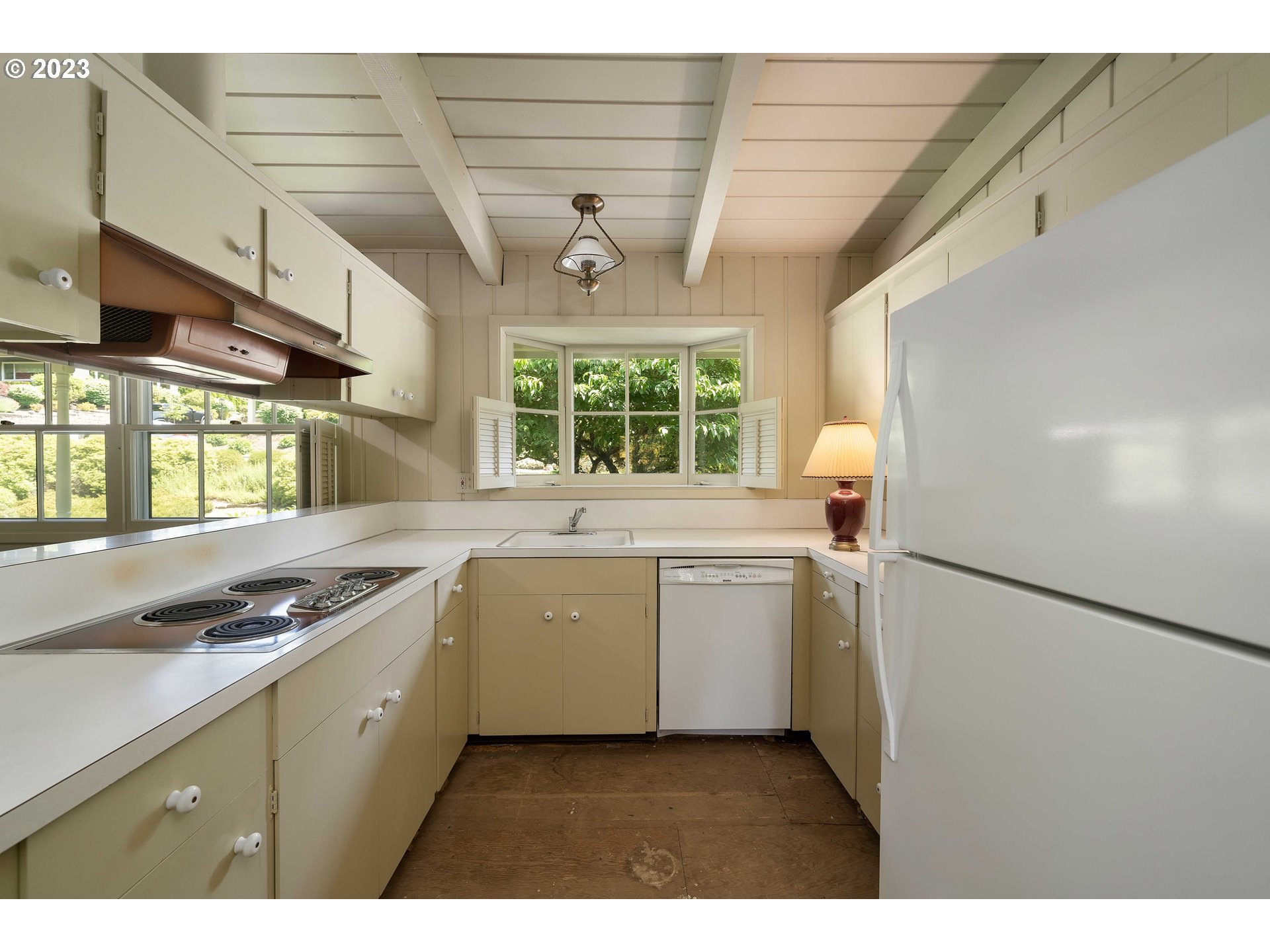 3815 Southwest 50th Avenue Portland, OR 97221 - Photo 6 of 36 a kitchen with a refrigerator and windows
